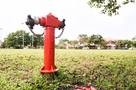 Red fire hydrant at strategic residential with residential house in backgroundの写真素材