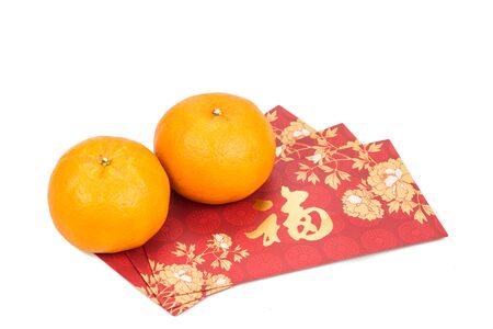 Mandarin oranges and red packets with Good Luck message in Chinese character on white backgroundの写真素材