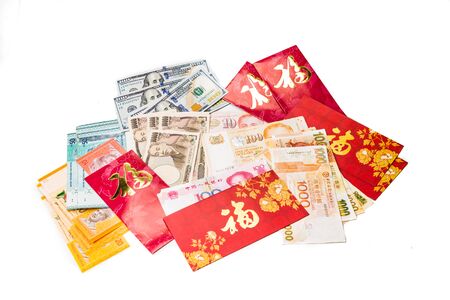 Hung Bao or red packet with Good Fortune Chinese character scatted with various currency notesの写真素材