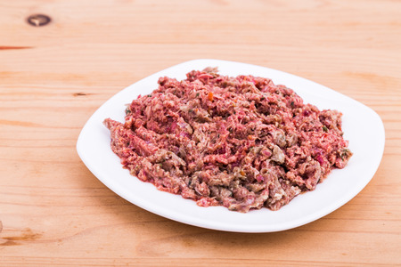 Fresh nutritious and delicious minced raw meat dog food on plate