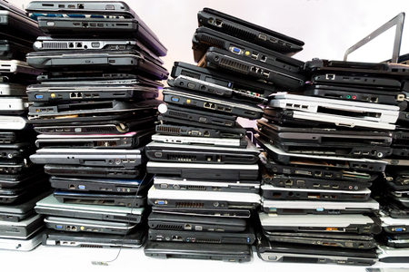 Stack of old, broken and obsolete laptop computer for repair and recycleの写真素材