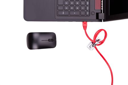Concept of computer network security with padlock over network cable connected to laptop computerの写真素材