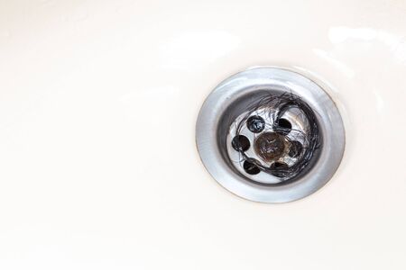 Bunch of hair trapped at bathroom wash basin drain outletの写真素材