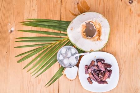 Top view of coconut juice and sweet dates are simple and common iftar break fast food for muslim during Ramadan fasting monthの写真素材