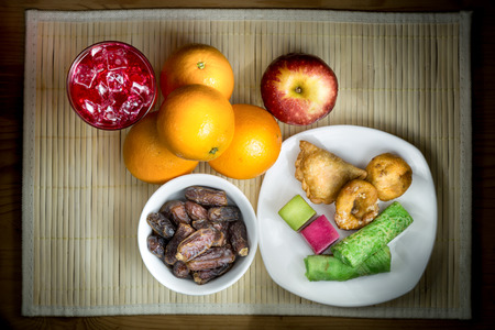 Cold refreshing syrup drinks, sweet dates, kuih are simple and common iftar break fast food during fasting month of Ramadanの写真素材