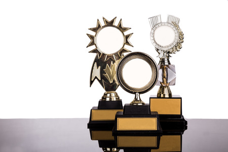Group of gold medal trophy with space for text on white background