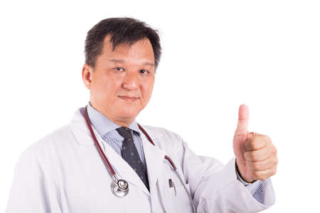 Matured, confident Asian male medical doctor with stethoscope and in white coat displays thumb upの写真素材