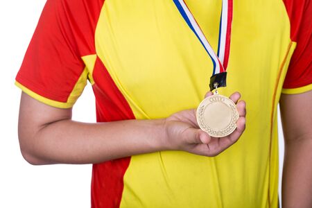Athlete wearing his winning generic gold medal on his neckの写真素材