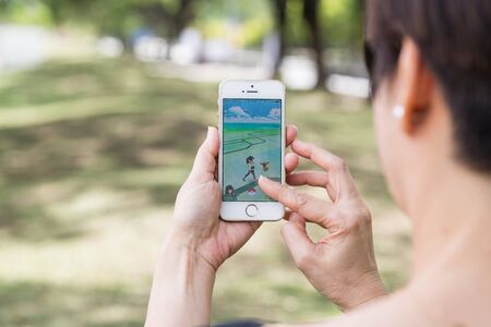 KUALA LUMPUR, MALAYSIA, JULY 24, 2016: An IOS user plays Pokemon Go, a free-to-play augmented reality mobile game developed by Niantic for iOS and Android devices.のeditorial素材