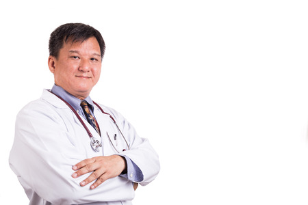 Confident matured Asian doctor with folded arms on white backgroundの写真素材