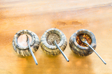 Salt, pepper, chili flakes spices in container on table