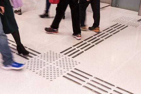Indoor tactile paving foot path for the blind and vision impaired handicap in Hong Kongの写真素材