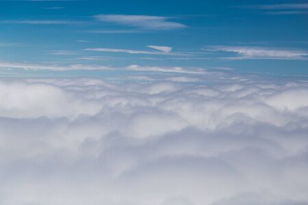 Scenic beautiful cloudscape view from plane flight windowの写真素材