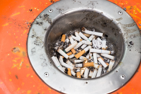 Dirty and harmful cigarette butts in ash trayの写真素材