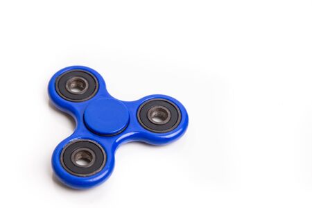 Blue fidget spinner hobby device in white backgroundの写真素材