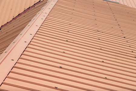 Strip of running metal roof of a building provides shelter