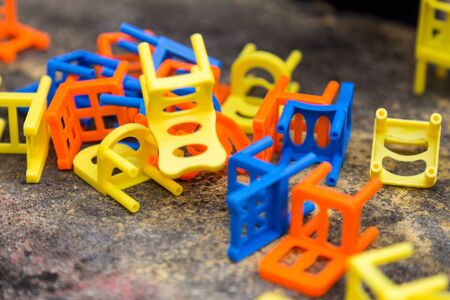 Heap of colorful stacking chair game toy on tableの写真素材
