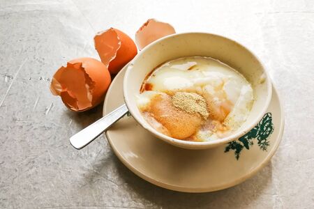 Asian popular traditional breakfast of half boiled eggs with soy sauce and pepper