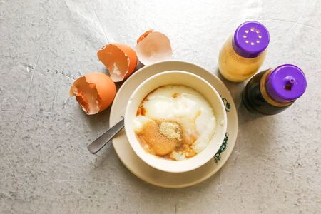Asian popular traditional breakfast of half boiled eggs with soy sauce and pepperの写真素材