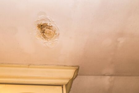 Roof leakages results ugly corrosion and damage on plaster ceiling