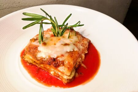 Closeup of fine dining italian lasagna served on elegant styleの写真素材