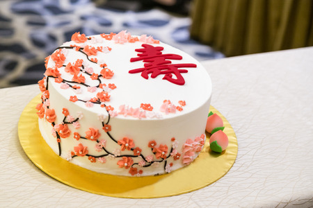 Decorated birthday cake celebration for eldery person with Chinese word Longevityの写真素材