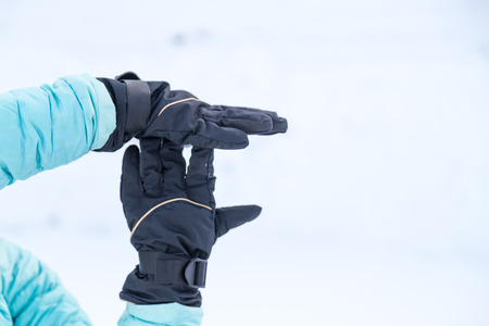 Hand in winter glove gesture break or halt on snow backgroundの写真素材