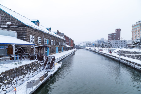 Otaru, Japan, January 28, 2018:  Otaru canal with nostalgic buidings is popular tourist destination in Hokkaido.  Featured here the canal during winter with thick snow.のeditorial素材