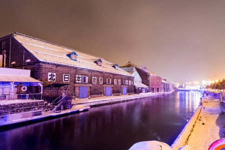 Otaru, Japan, January 28, 2018:  Otaru canal with nostalgic buidings is popular tourist destination in Hokkaido.  Featured here night scene of the canal during winter with thick snow.のeditorial素材