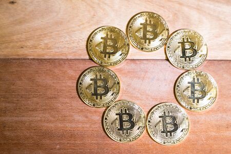 Conceptual cryptocurrency bitcoins on wooden tableの写真素材
