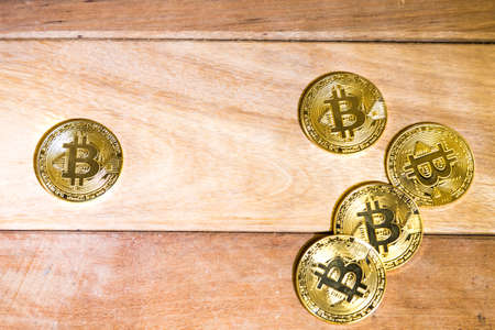 Conceptual cryptocurrency bitcoins on wooden tableの写真素材