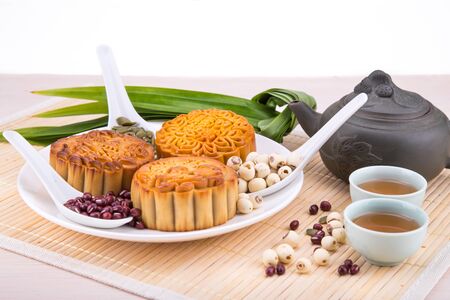 Mooncake for Chinese mid-autumn festival celebration, wih ingredients and tea on table topの写真素材