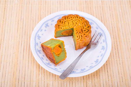 Overhead view of mooncake with egg yoke for Chinese mid-autumn festive served on plateの写真素材