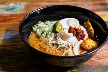 Serving of Nyonya Laksa, popular spicy noodle soup delicacy in Malaysiaの写真素材