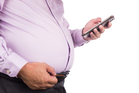 Men pinching own unhealthy big tummy with visceral or subcutaneous fats. Pose health risk.の写真素材