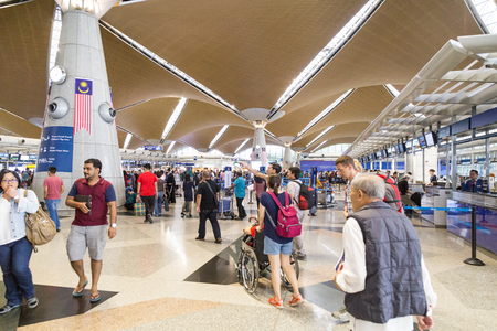 KUALA LUMPUR, MALAYSIA, November 3, 2018: Travelers walking around identifying their flights check-in counters at the main departure hall of KLIA Airportのeditorial素材