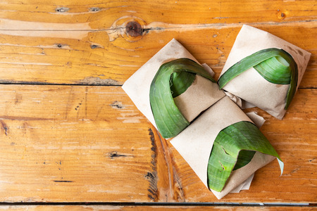 Simple authentic nasi lemak wrapped in banana leaf, popular breakfast in Malaysiaの写真素材