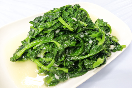 Stir fry dau miu, or snow pea sprout vegetable, available during winter season in Hong Kong and China.の写真素材