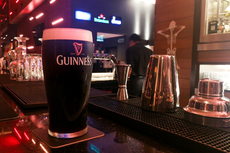 KUALA LUMPUR, MALAYSIA, APpril 18, 2019: Guinness is an Irish dry stout that originated in the...