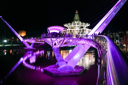 KUCHING, MALAYSIA, April 18, 2019: The Darul Hana bridge across Sarawak River overseeing the Sarawak State Assembly Building is popular tourist destination in Kuching.のeditorial素材