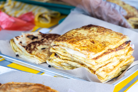 Seller preparing murtabak at street stall for iftar during muslim fasting month of Ramadan.の写真素材