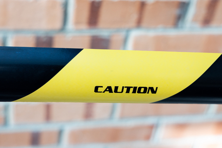Closeup of Caution tape barricade area from access from premise locationの写真素材