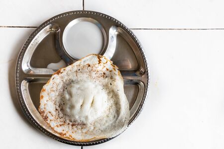 Apom or apam, traditional sweet Malaysia food of Indian origin, served on plate with coconut milk dipの写真素材