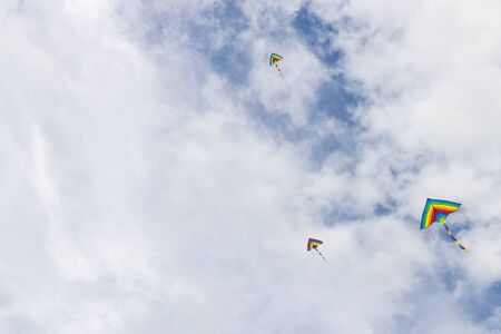 Coloful kites flying against blue sky with copy space as graphic resource