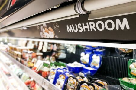 Mushroom signage at supermarket produced food section with defocused background
