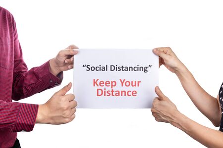 Two person with thumbs up holding placard with Social Distancing, Keep Your Distance words, with...