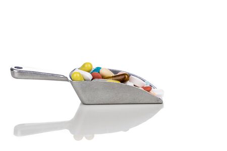 Healthcare concept of ladle with  scoop of various medicine tablet, caplets, pills, capsule on white backgroundの写真素材