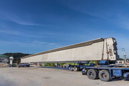 Truck transport pre-fabricated concrete beam to construct light rail transit infrastructure in...