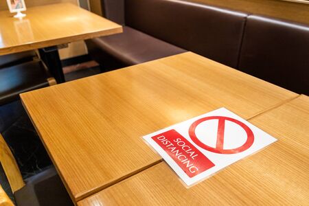 New normal with table signage prohibit occupancy to maintain social distance to contain spread of coronavirusの写真素材