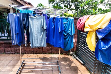 Laundry fabric being dried under bright hot sun in home compound after wash in Malaysia